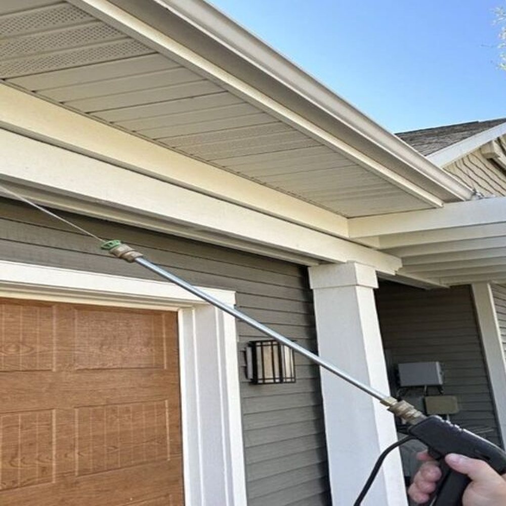 DeadOne technician treating the eaves of a home